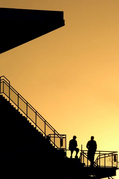 stock image  silhouettes at sunset stadium stairs