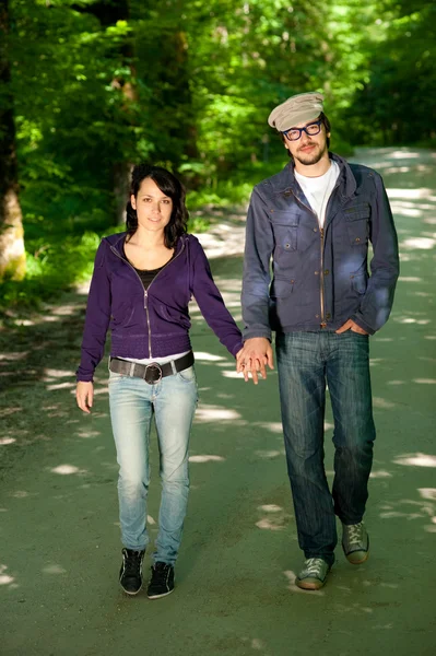 Young walks couple in forest — Stock Photo, Image