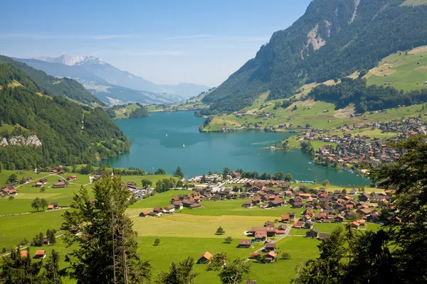 stock image View to a town on a lake in mountains