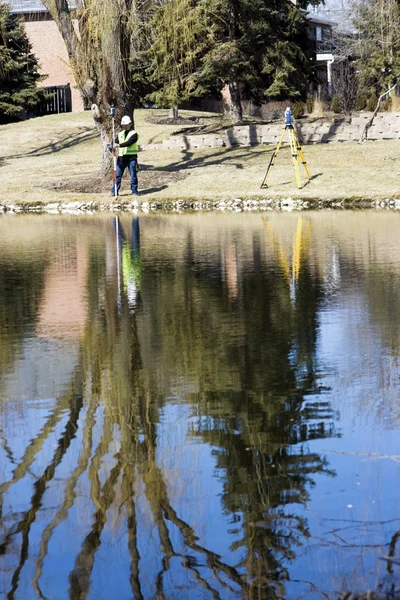 Taking measurements by the lake — Stock Photo, Image