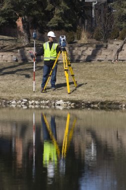 Surveyor working with robotic station clipart