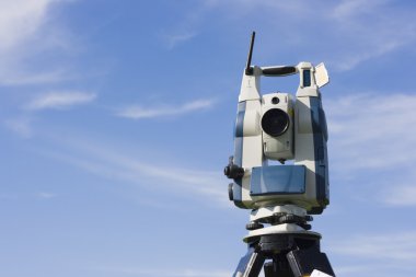 Theodolite against blue sky clipart