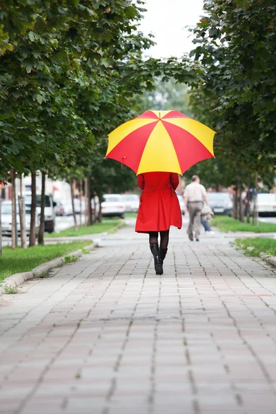 stock image Woman walking with an umbrella