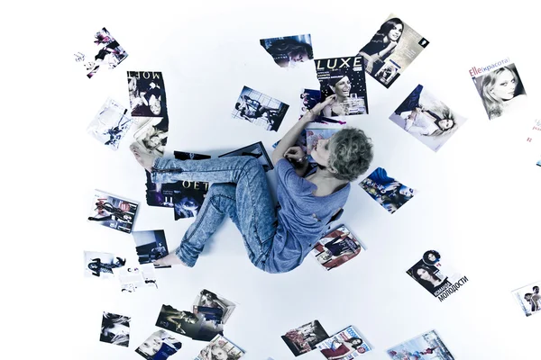 stock image Atrractive young girl among the magazines