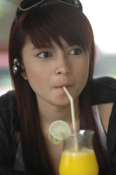 Young lady drinking orange juice — Stock Photo, Image