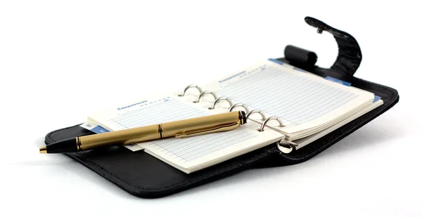 The opened pad and the pen on a white background — Stock Photo, Image