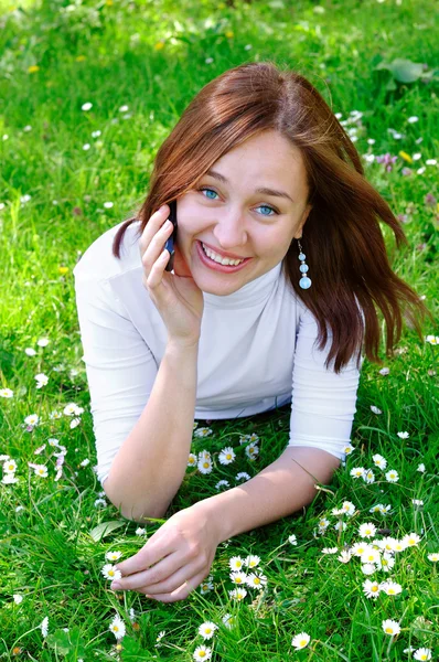 The girl with the phone on the grass — Stock Photo, Image
