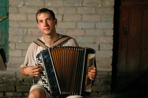 Stock image Happy button accordion player