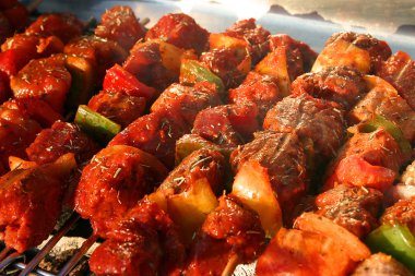 Few Meat Brochettes on a Barbecue clipart