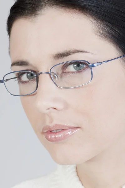 Close-up of a beautiful young woman with glasses — Stock Photo, Image