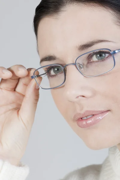Close-up of a beautiful young woman with glasses — Stock Photo, Image