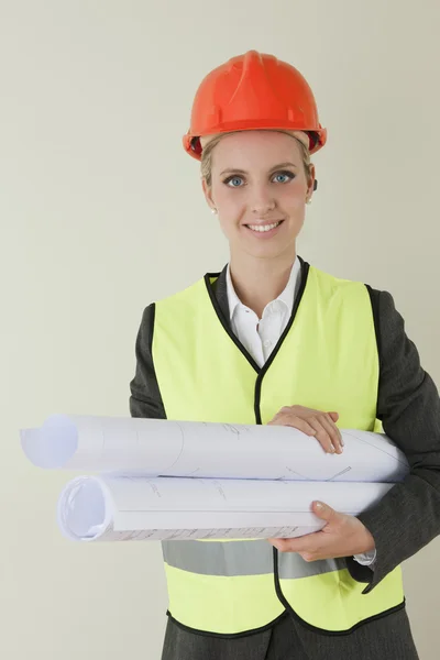 Female architect/engineer/building contractor with blueprints — Stock Photo, Image