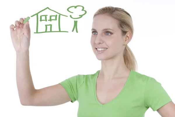 Woman drawing house and tree — Stock Photo, Image