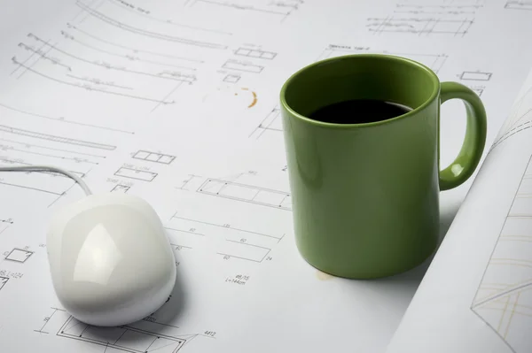 Coffee cup on blueprints — Stock Photo, Image