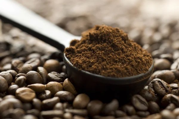 Coffee beans and ground with spoon