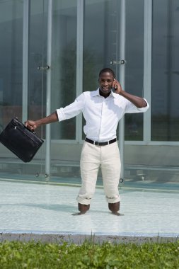 Businessman inside a pool speaking on the phone