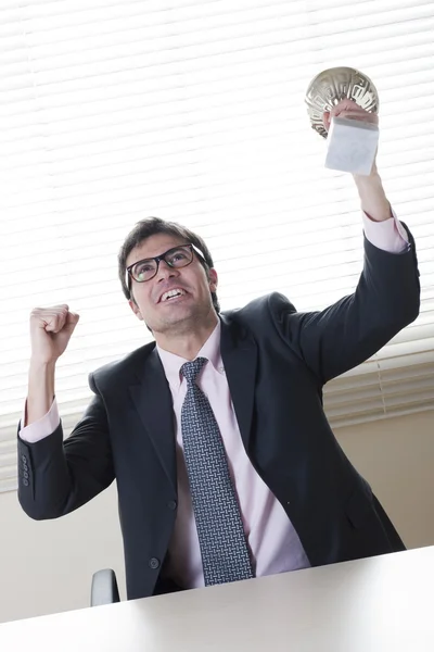 Businessman celebrating raising a cup — Stock Photo, Image