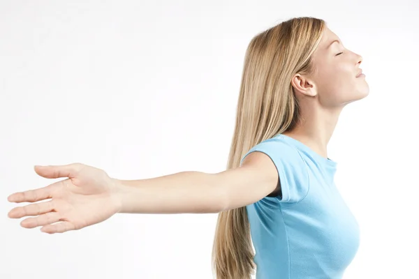 Relaxed young woman with arms outstretched — Stock Photo, Image