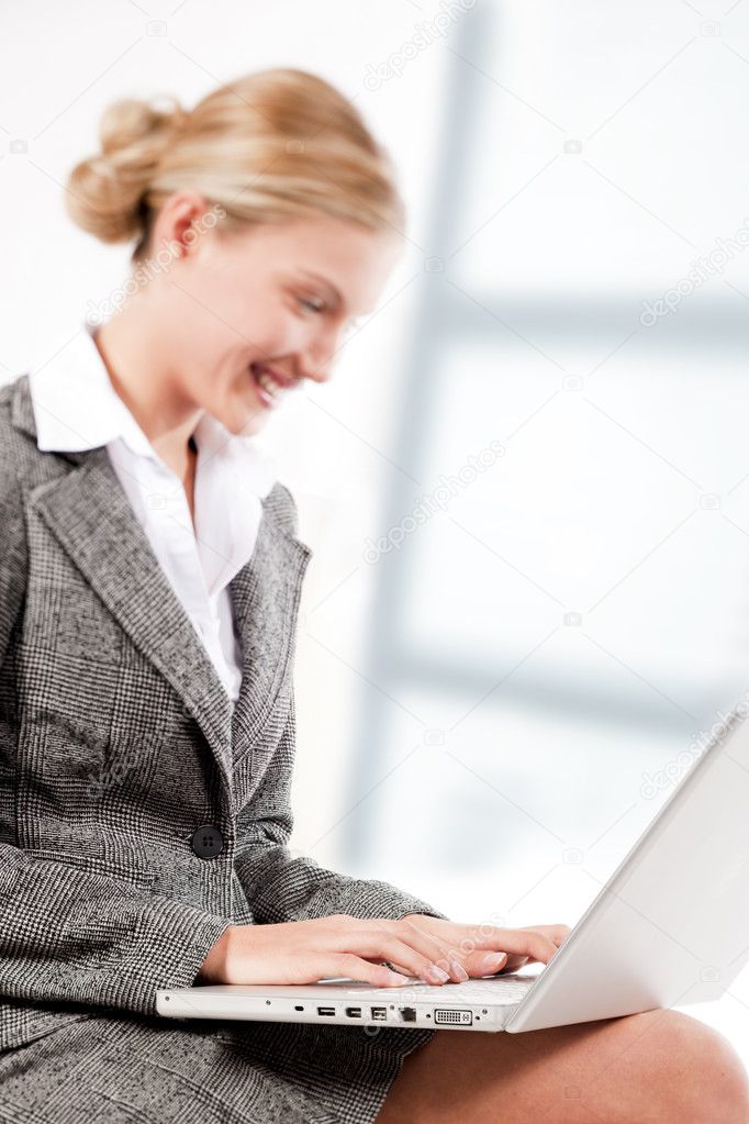 Beautiful business woman working on her laptop