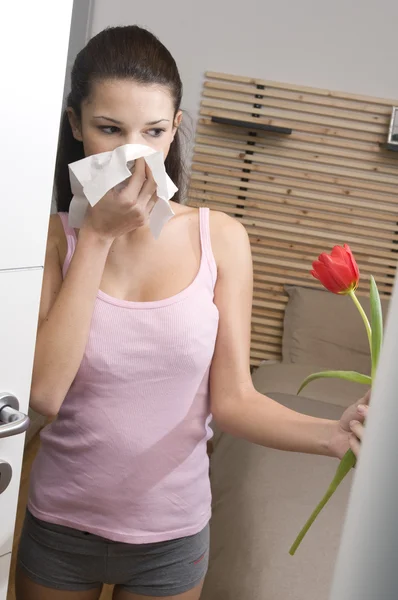 Teenage girl smelling a tulip in her bedroom — Stock Photo, Image