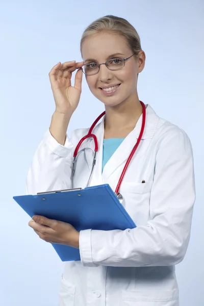 Beautiful female doctor with clipboard — Stock Photo, Image