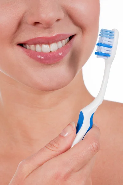 Close-up of a yougn woman smile with toothbrush Royalty Free Stock Images