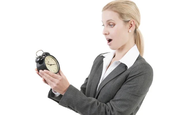 Businesswoman looking shocked at the clock — Stock Photo, Image