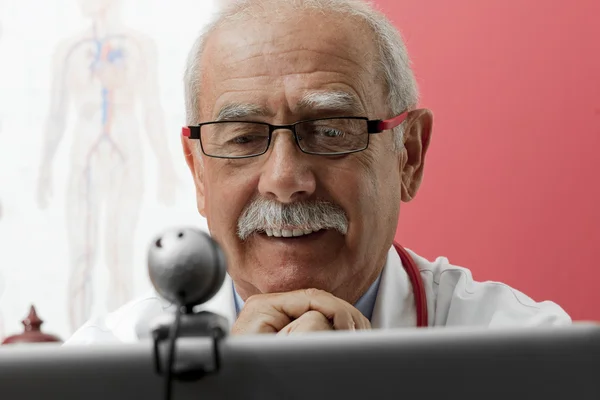 Médico sorridente usando webcam — Fotografia de Stock