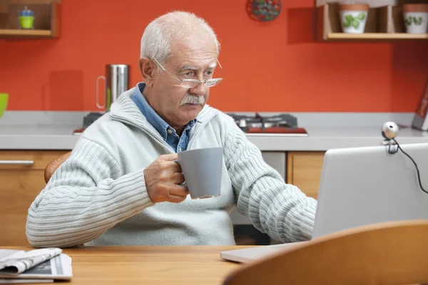 Senior man speaking through webcam — Stock Photo, Image