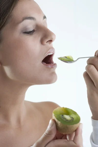 Frau isst Kiwi — Stockfoto