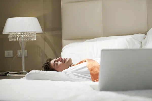 Yatakta yatarken yorgun işadamı — Stok fotoğraf