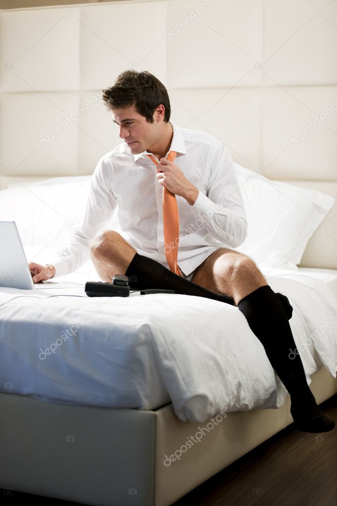 Relaxed Businessman Working in Bed