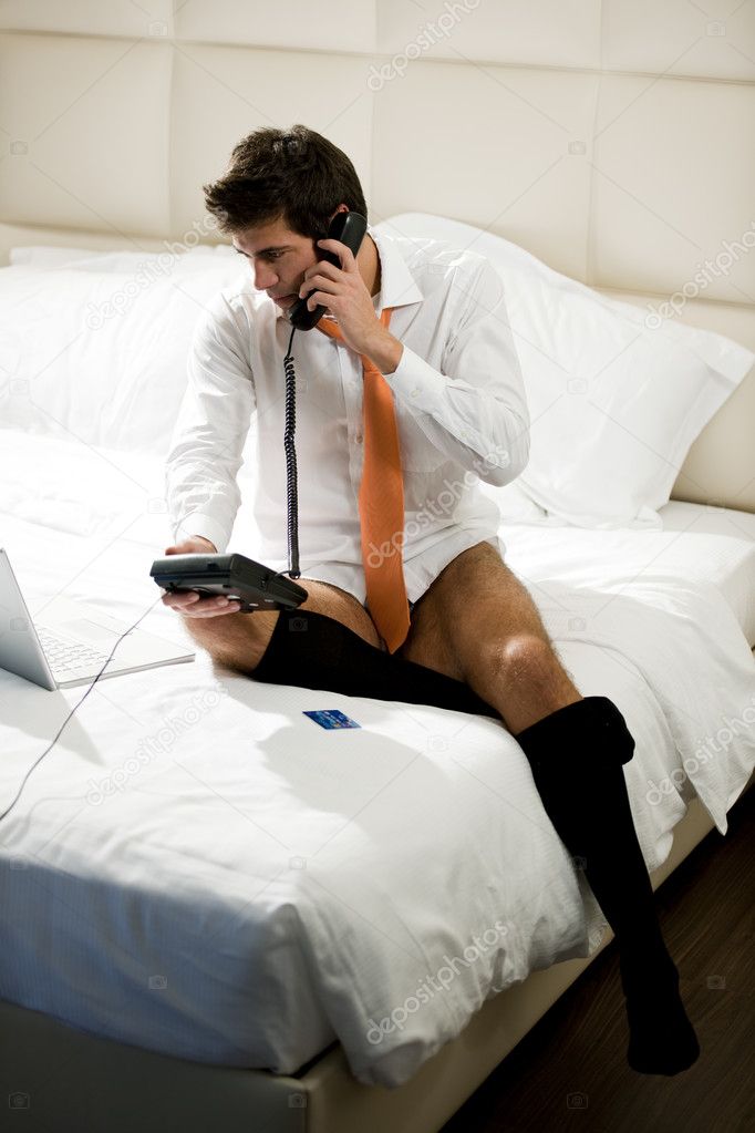 Relaxed Businessman Making Phone Reservation