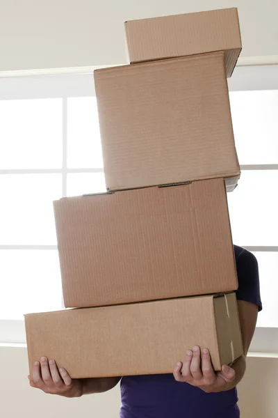 Hombre llevando cajas apiladas — Foto de Stock