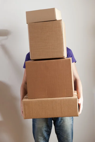 Homem transportando caixas empilhadas — Fotografia de Stock
