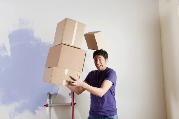 Uomo che trasporta scatole impilate — Foto Stock