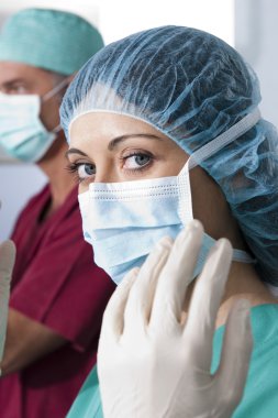 Portrait of a female surgeon, operation in the background clipart