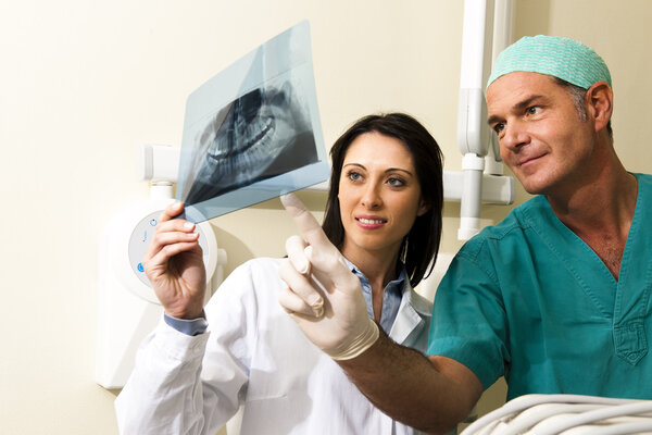 Two Dentists examining x-ray