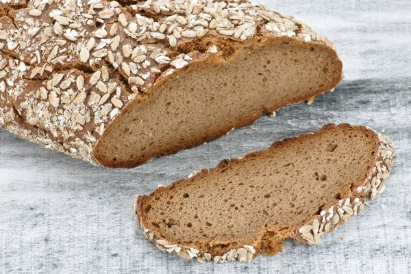 stock image Wholegrain bread on wooden table, healty food