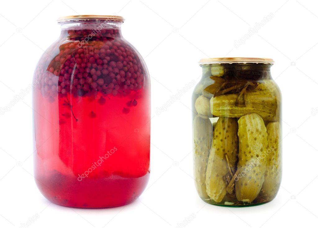 Glass jars with compote and cucumbers