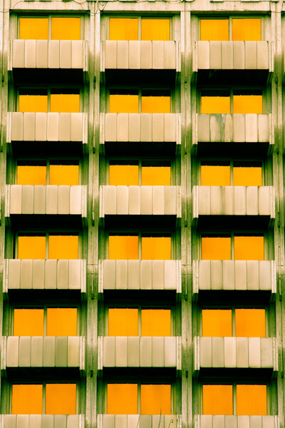 Symmetrical features of a building with yellow windows.