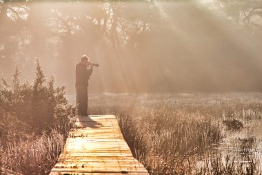 Photographer at sunrise clipart