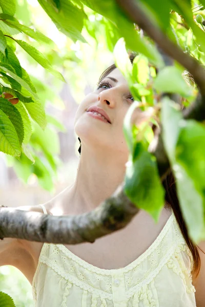 Schönes Mädchen zwischen den Bäumen — Stockfoto