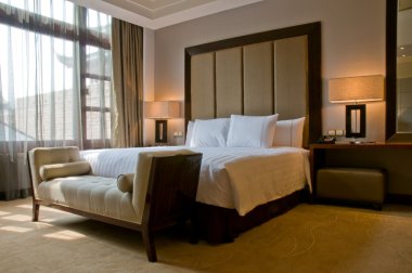 Bedroom of a elegant 5 star luxury hotel clipart