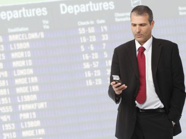 Businessman calling on mobile phone on airport