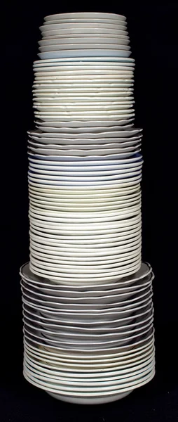 Pile of plates on a black background. — Stock Photo, Image