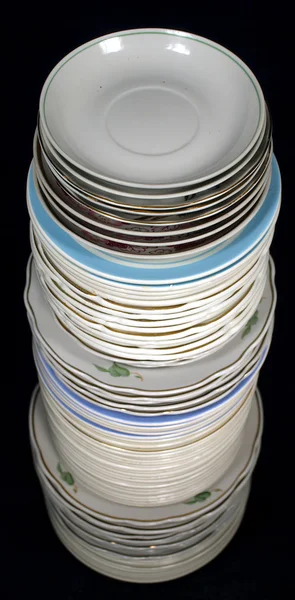 Pile of plates on a black background. — Stock Photo, Image