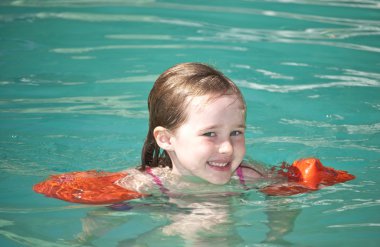 Young girl swimming clipart