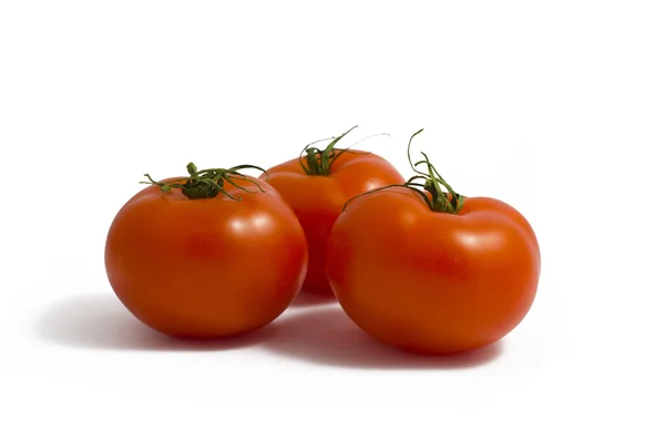 Три помидора на белом — стоковое фото