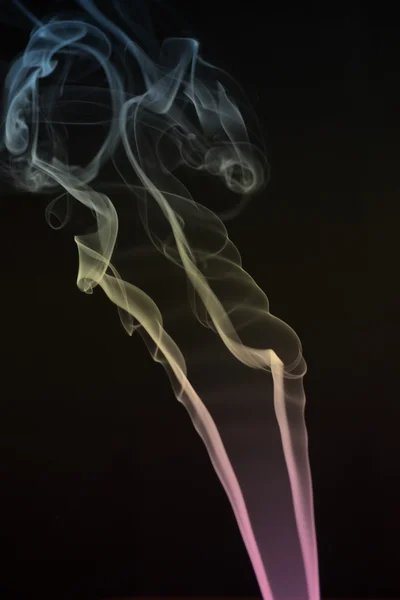 Кольоровий дим на чорному тлі — стокове фото